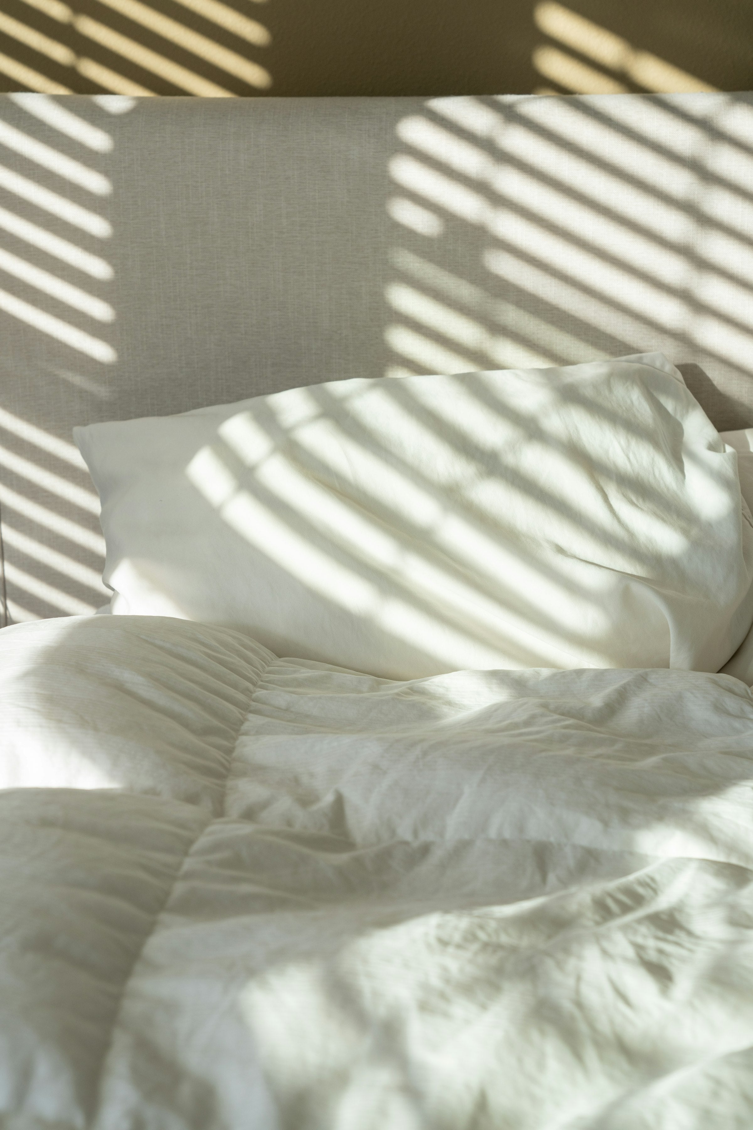 Bed with white sheets and pillows