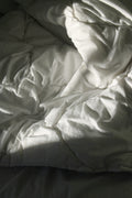 Soft white textile folded on a wooden surface