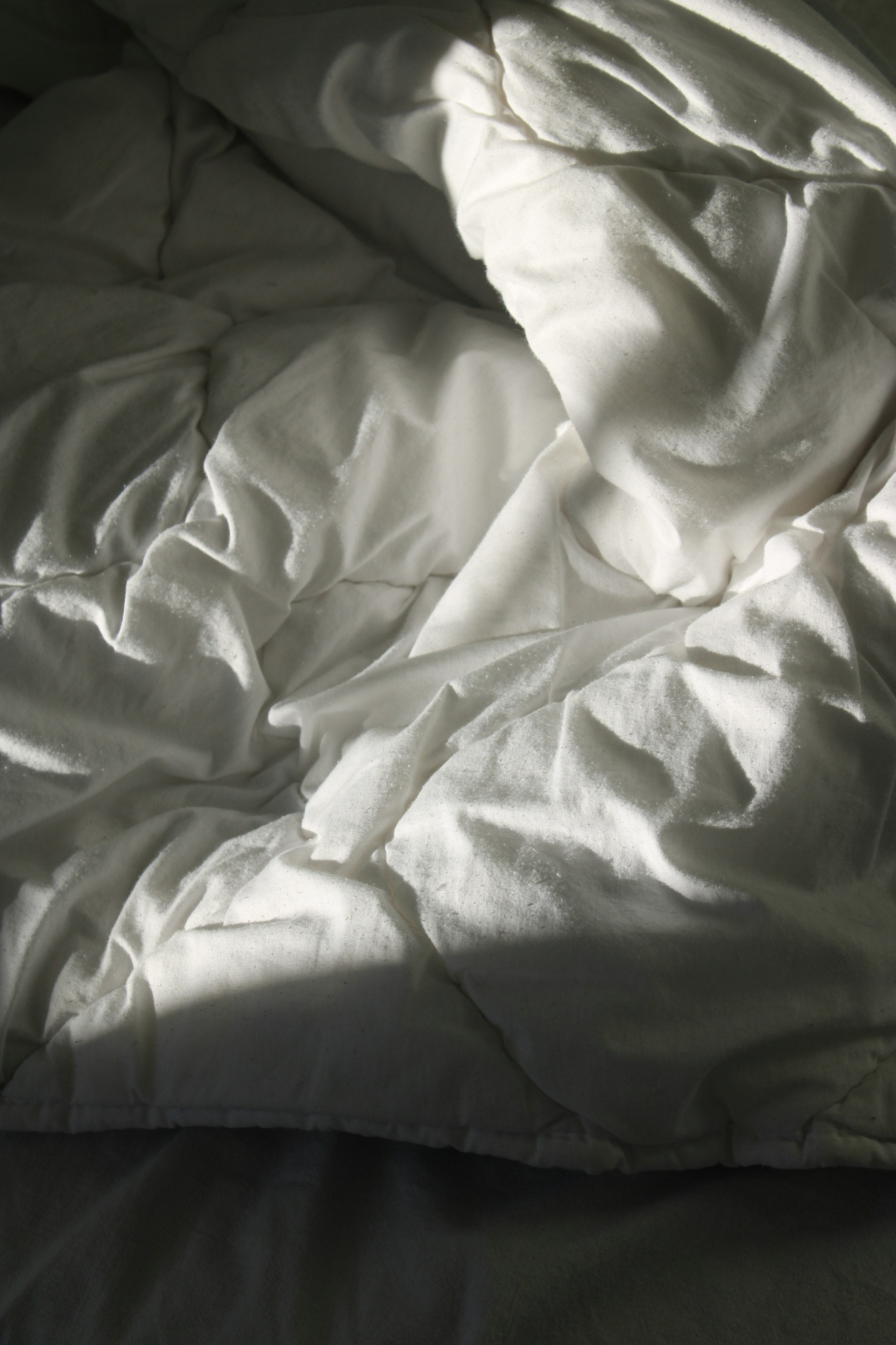 Soft white textile folded on a wooden surface