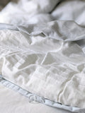 Folded bed sheet set in a neutral striped fabric