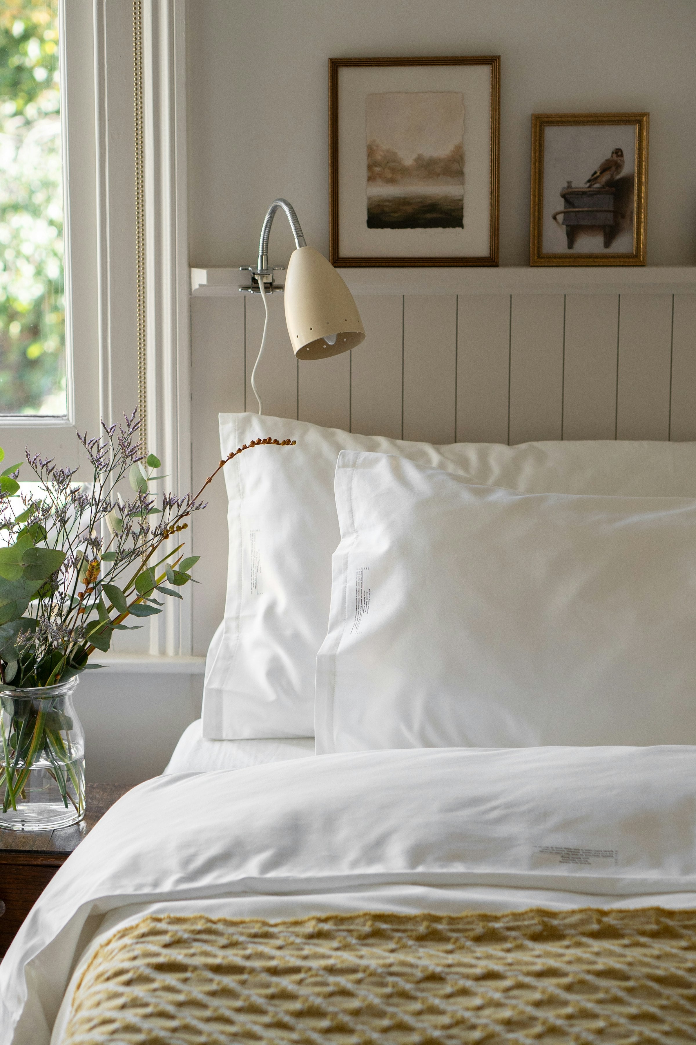 Bed with supportive pillows arranged against the headboard